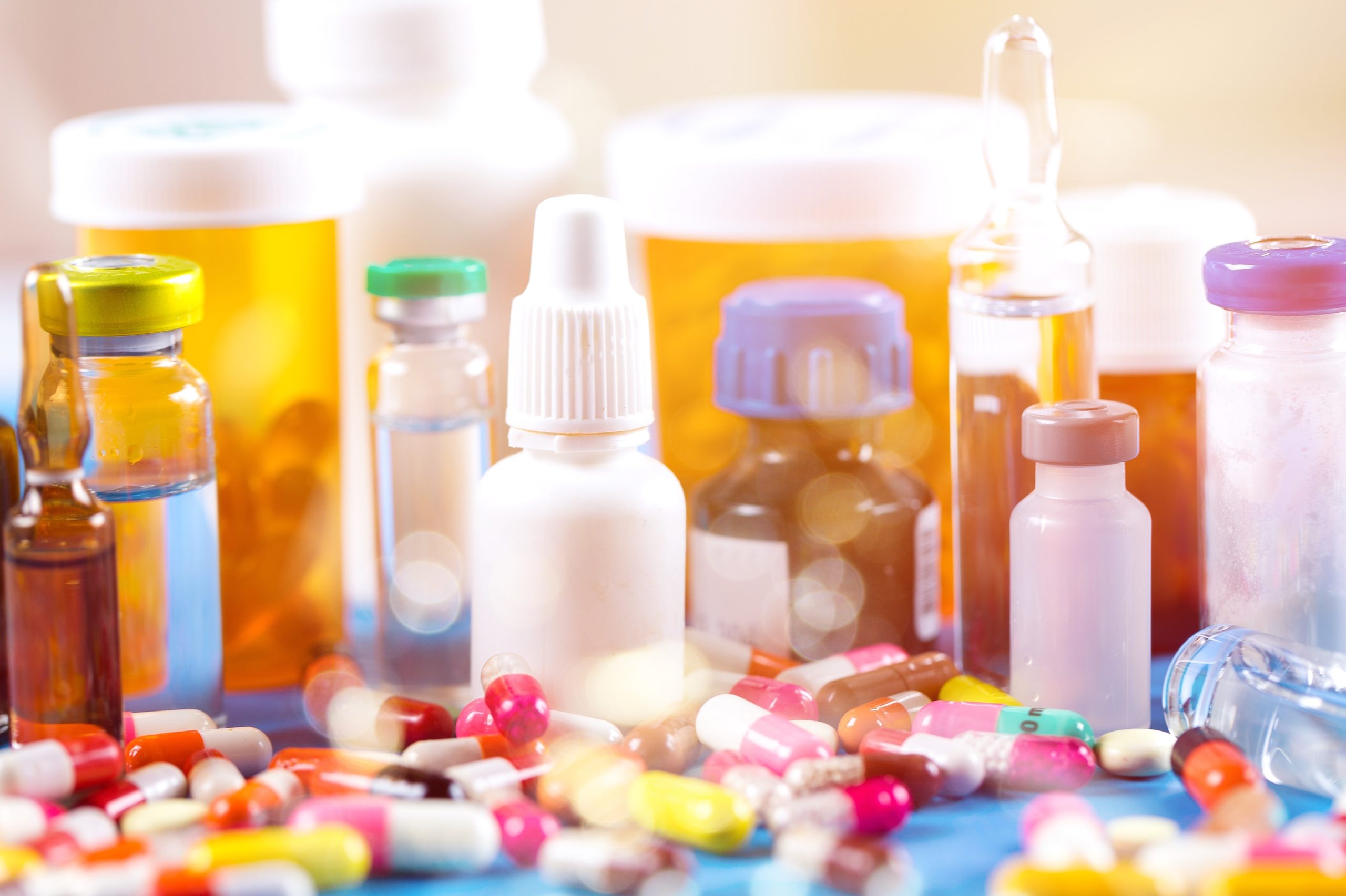 Colorful pills and tablets on medical background